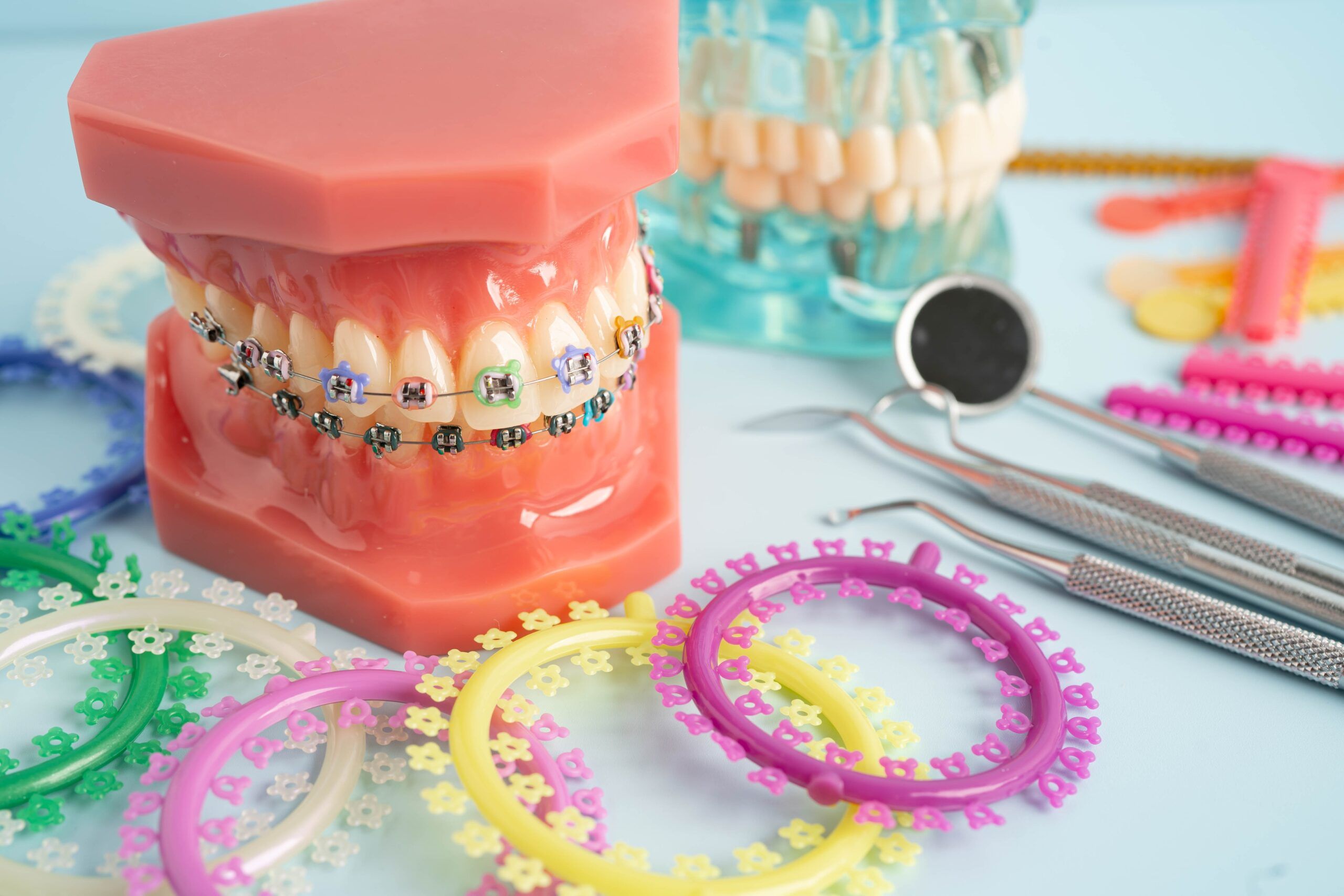 a display of orthodontic instruments and model with braces