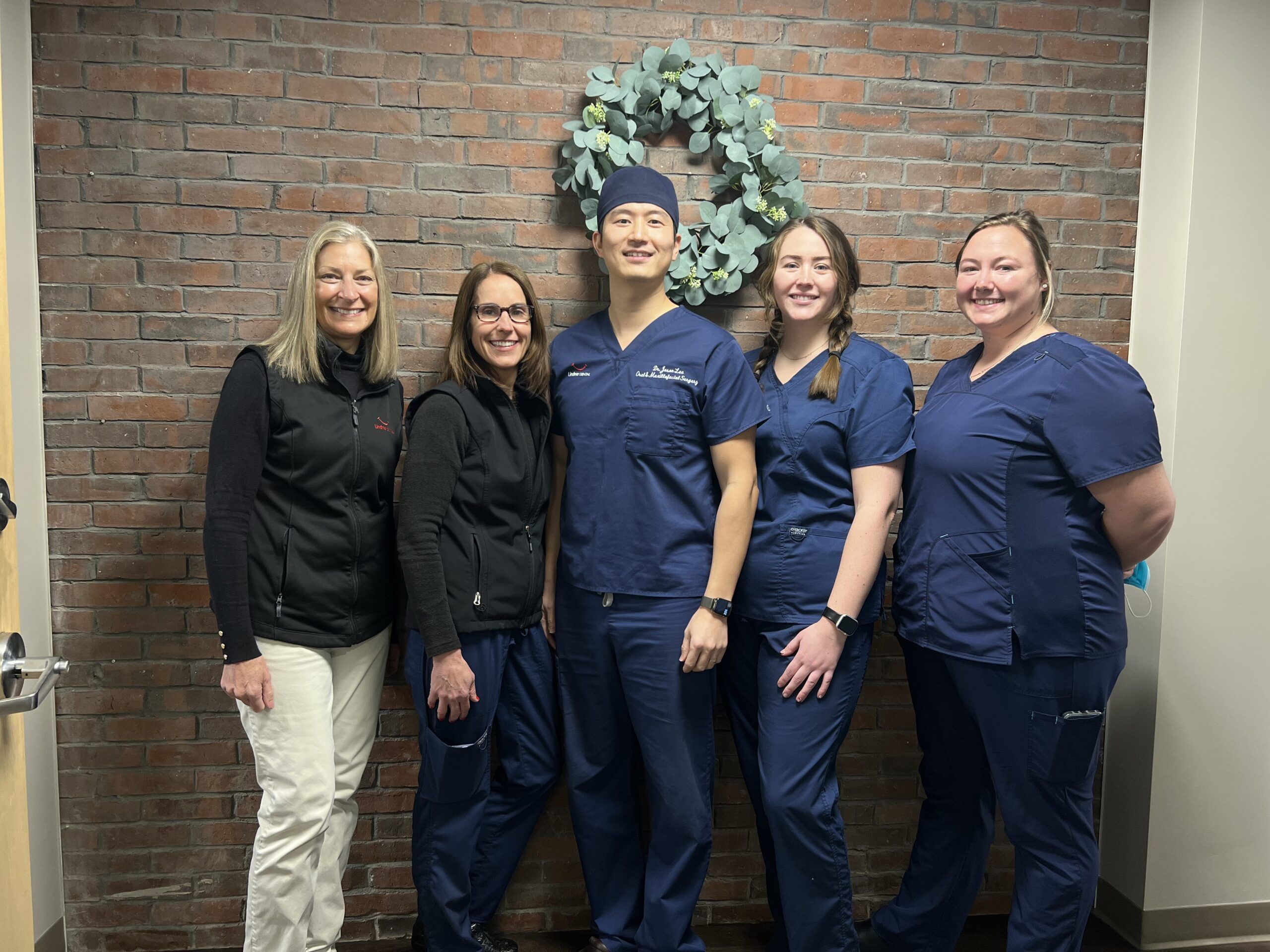 oral surgery team surrounding Dr Lee at Lindner Dental