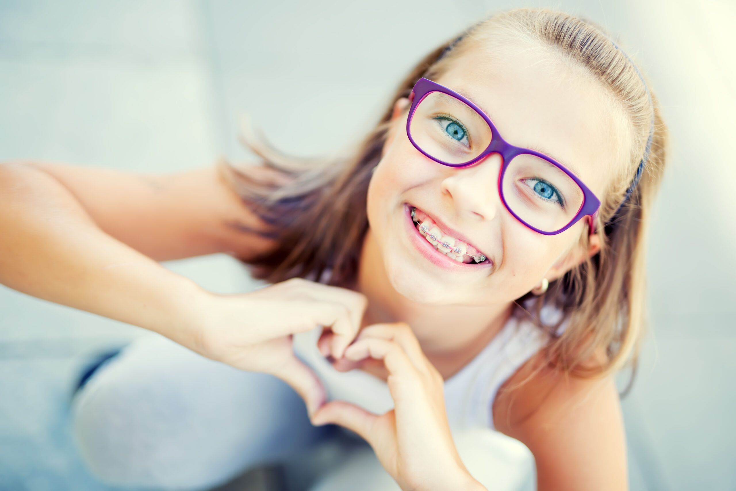 young girl smiling with braces on